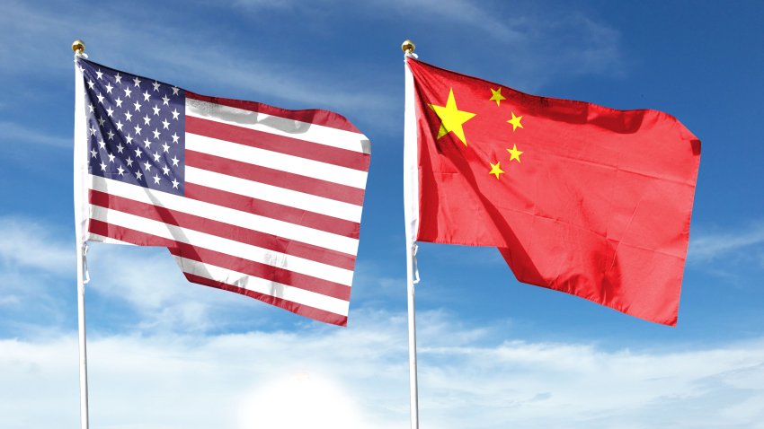 American flag and Chinese flag on cloudy sky. fly in the sky