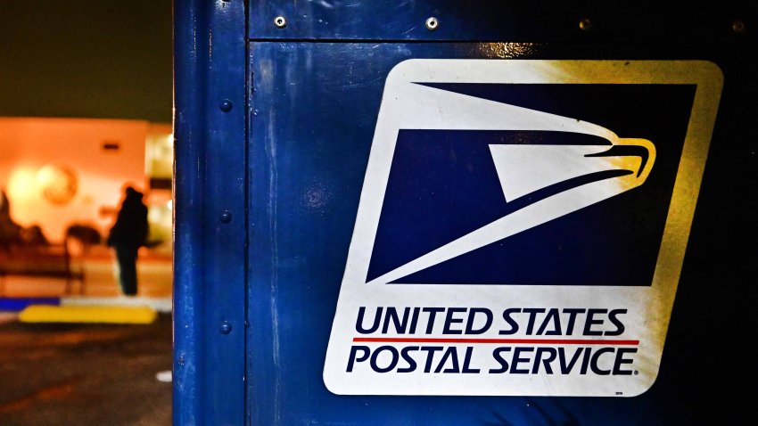 The United State Postal Service emblem is seen on the side of a mailbox in Monterey Park, California on February 4, 2025. The US Postal Service (USPS) said February 4, 2025 it was temporarily suspending inbound parcels from China and Hong Kong, shortly after President Donald Trump’s imposition of fresh tariffs targeting Beijing. The halt will take place “until further notice,” and follows Trump’s order for an additional 10 percent levy on Chinese imports starting Tuesday. (Photo by Frederic J. BROWN / AFP) (Photo by FREDERIC J. BROWN/AFP via Getty Images)