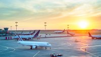 Airport with many airplanes at beautiful sunset