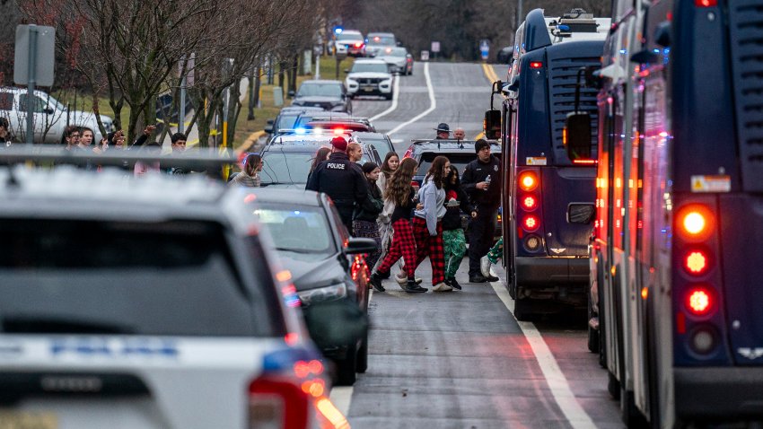 MADISON, WISCONSIN – DECEMBER 16:  Students from Abundant Life Christian School are escorted to a city bus where they will reunited with their parents after a school shooting on December 16, 2024 in Madison, Wisconsin. According to authorities, a juvenile opened fire in the school killing at least two and injuring at least six more people. The suspect was found dead inside the school by police.  (Photo by Andy Manis/Getty Images)