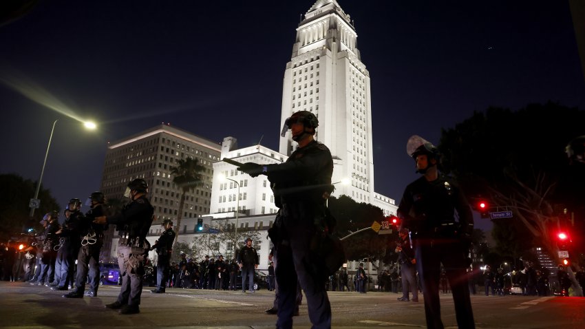 Los Angeles, CA - June 10: Police officers enforce curfew in downtown L.A. at City Hall on Tuesday, June 10, 2025 in Los Angeles, CA. (Jason Armond / Los Angeles Times via Getty Images)