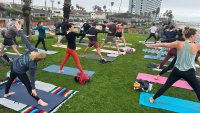 Yogis practice their warrior pose at Palisades Park in Pacific Beach, June 5, 2025.