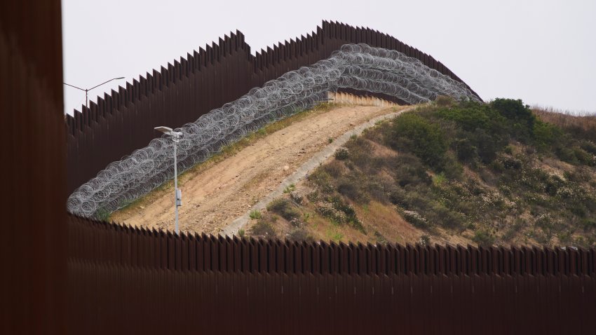 FILE &#8211; Concertina wire lines the interior of a border wall separating Tijuana, Mexico, from the United States, June 4, 2025, in San Diego. (AP Photo/Gregory Bull, File)