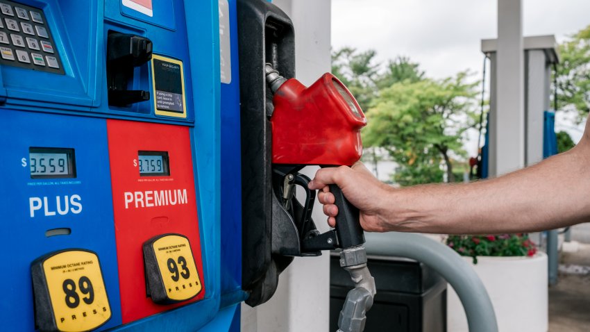Close-up of unrecognizable man holding fuel pump at gas station