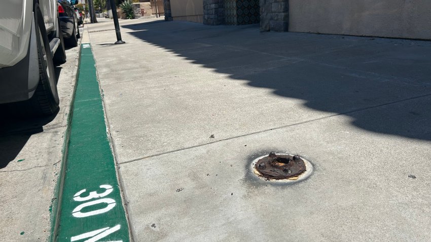 An exposed, rusted metal base is still a hazard on Albatross St and W. Washington St in Mission Hills. More than a year ago, a City of San Diego parking meter was removed leaving bolts and lugs protruding from the sidewalk, June 26, 2026.