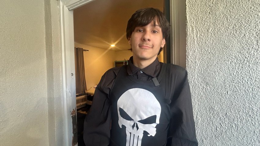 Robert, 19, stands at the door of his new home. He now lives at the HarborTAY House for young people 18-24, San Diego, Calif., July 23, 2026.