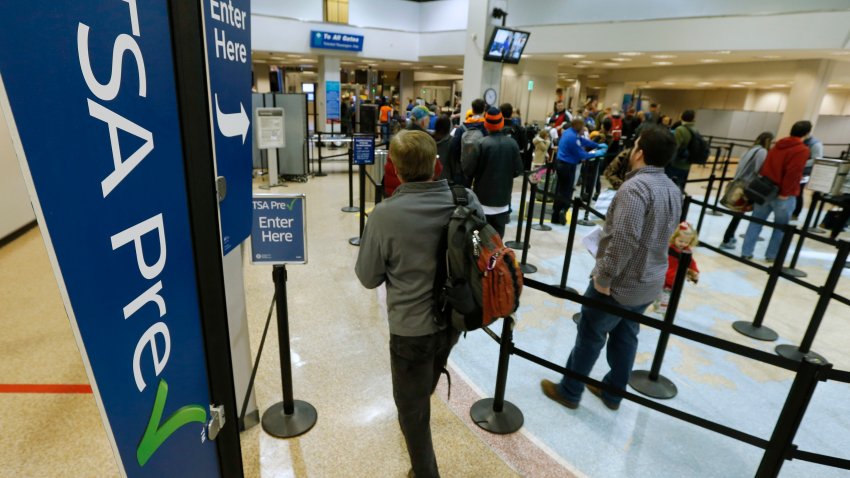 A passenger enters the Transportation Security Administration (TSA) pre-check line towards a security check point at Salt Lake City International Airport in Salt Lake City, Utah, U.S., on Tuesday, Dec. 23, 2014. The Washington-based Airlines for America trade group predicts 45 million people will fly in the U.S. during the 19-day holiday travel period. Photographer: George Frey/Bloomberg via Getty Images